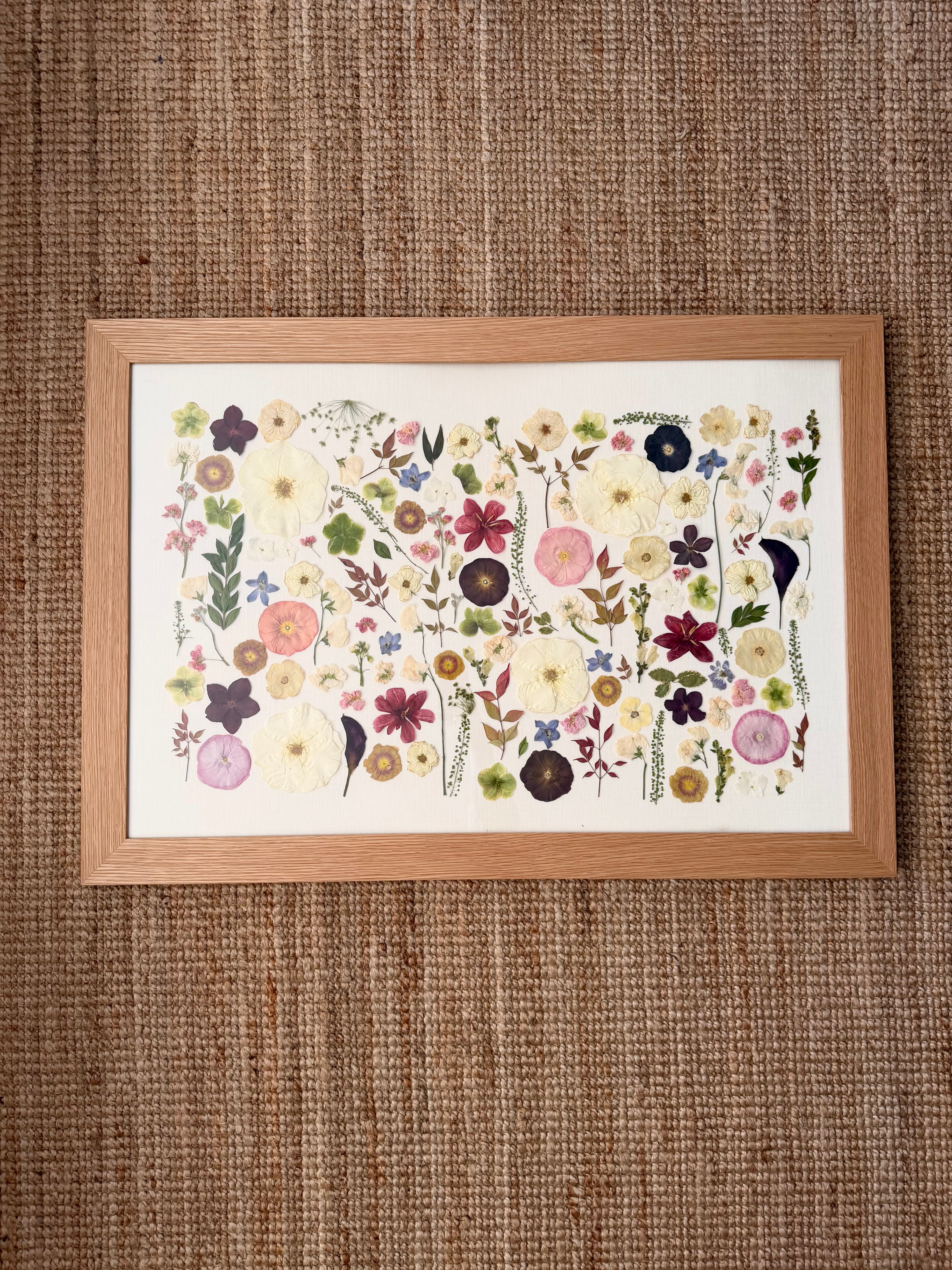 Framed floral artwork on a textured brown wall