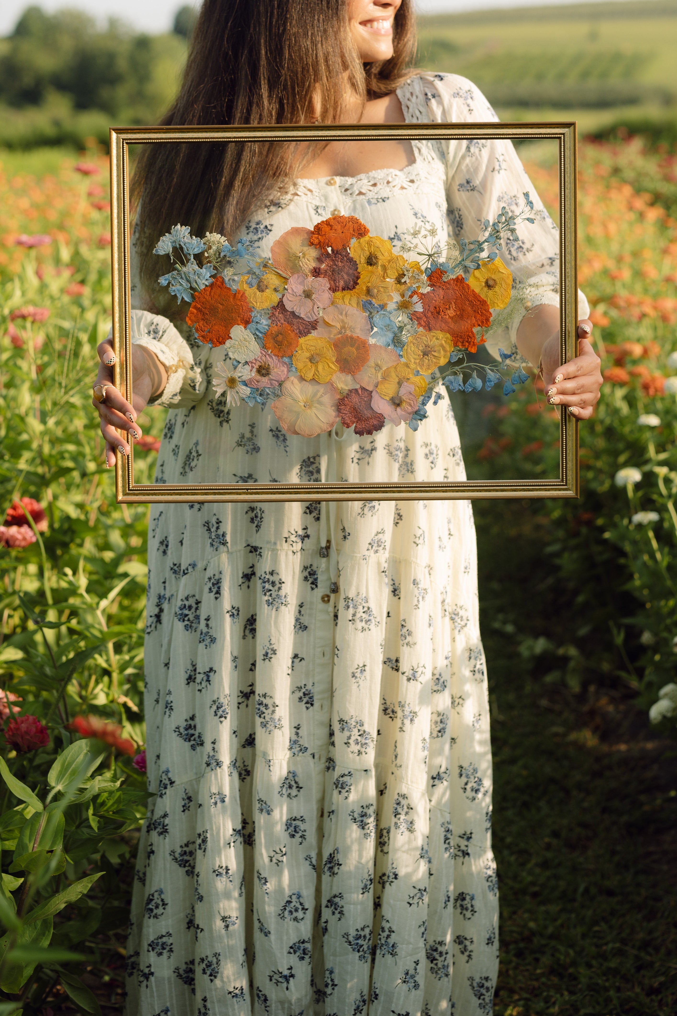 Elegant pressed floral bouquet arranged in gold keepsake frame